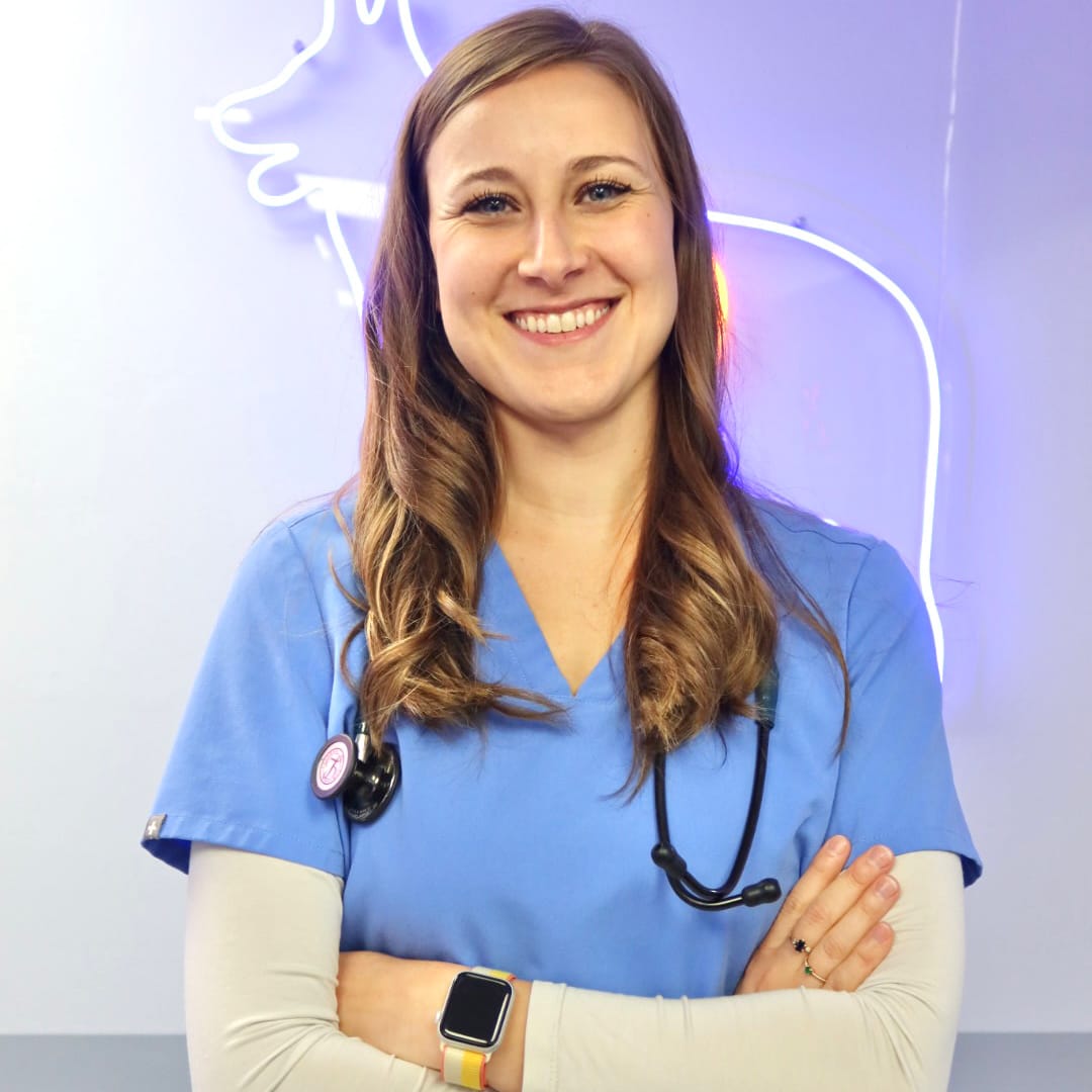smiling female veterinarian with arms folded